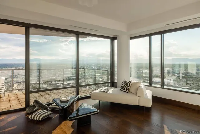 a living room with furniture and a floor to ceiling window