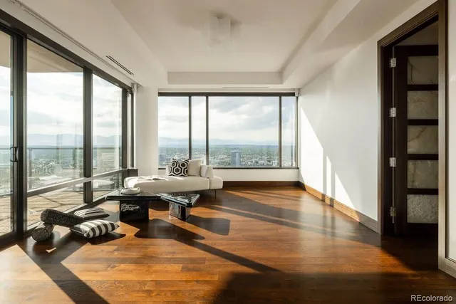 a living room with furniture and floor to ceiling window