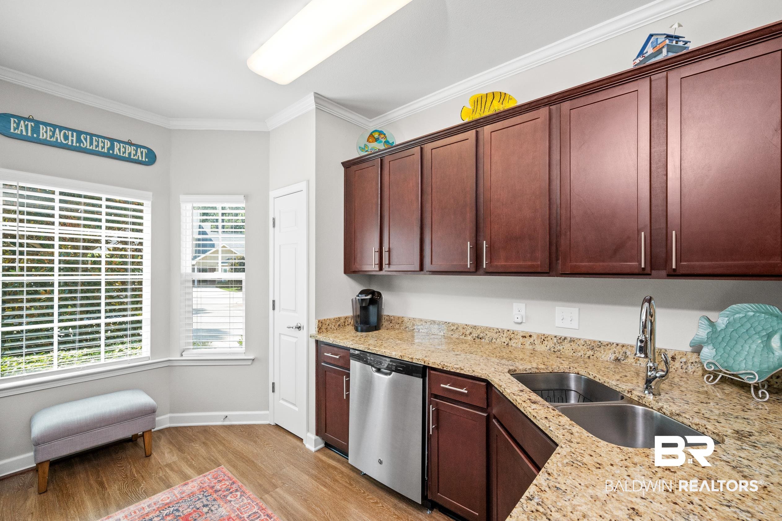 430 West Fort Morgan Road, Unit 1902 Gulf Shores, AL 36542 - Photo 13 of 59 Kitchen featuring light hardwood / wood-style flooring, dishwasher, light stone counters, sink, and ornamental molding