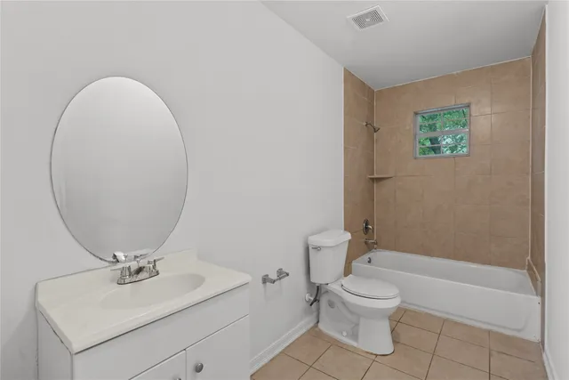 a bathroom with a toilet a sink and a mirror