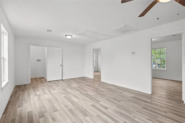 a view of an empty room with wooden floor