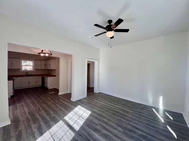 a view of an empty room and wooden floor