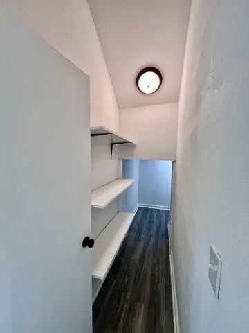 a view of a hallway with wooden floor