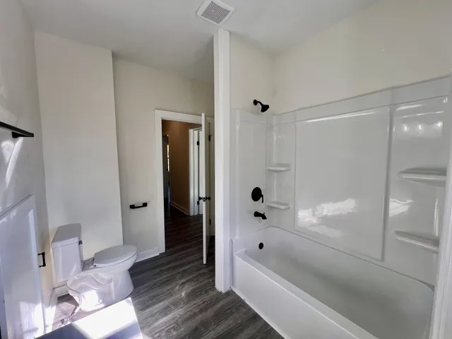 a bathroom with a bathtub and a shower