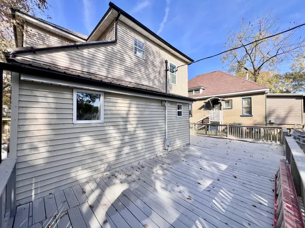 a view of a house with wooden deck