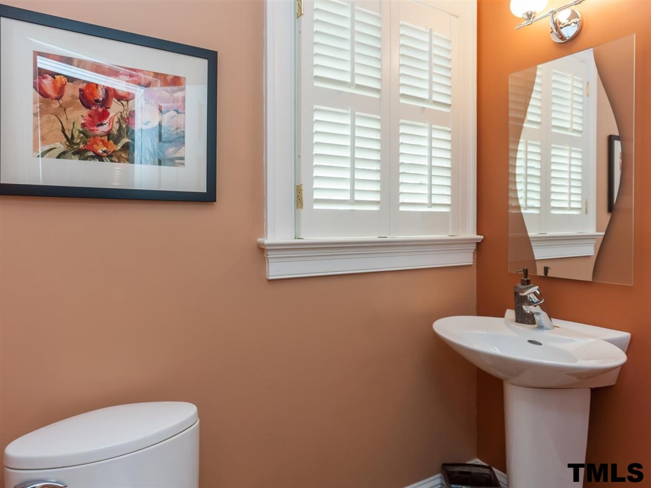 1914 Sunset Drive Raleigh, NC 27608 - Photo 8 of 25 a bathroom with a toilet a sink and a mirror