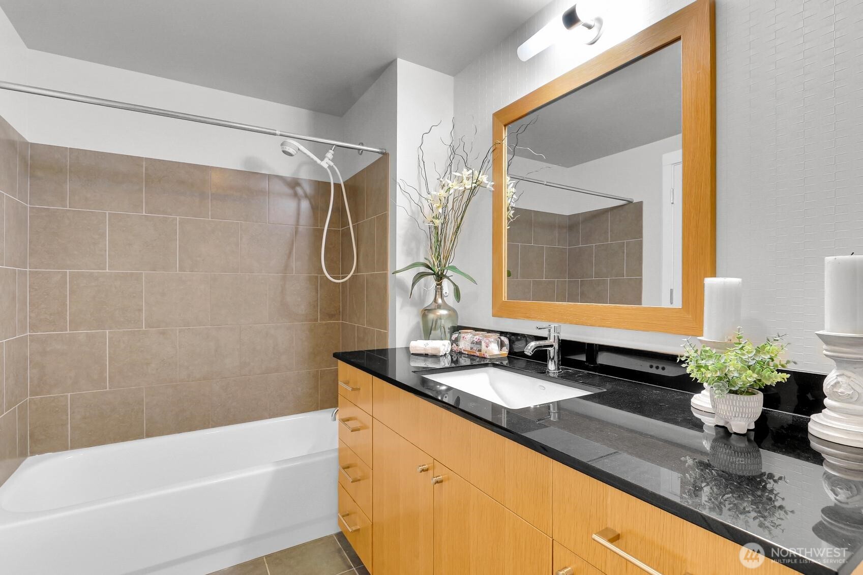 76 Cedar Street, Unit 808 Seattle, WA 98121 - Photo 11 of 20 a bathroom with a granite countertop sink a mirror a and a bathtub