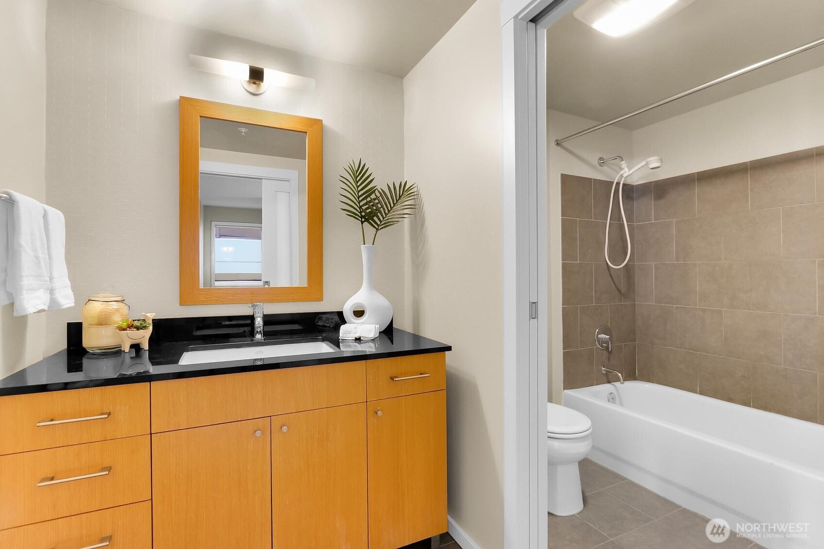 76 Cedar Street, Unit 808 Seattle, WA 98121 - Photo 15 of 20 a bathroom with a granite countertop sink toilet and shower