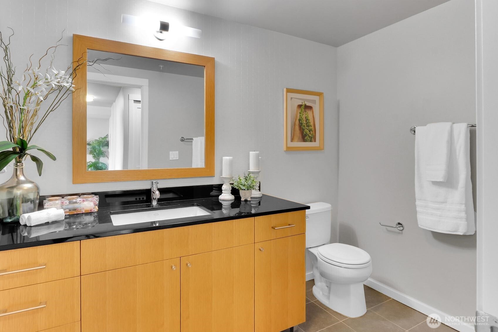 76 Cedar Street, Unit 808 Seattle, WA 98121 - Photo 10 of 20 a bathroom with a granite countertop sink mirror vanity and toilet