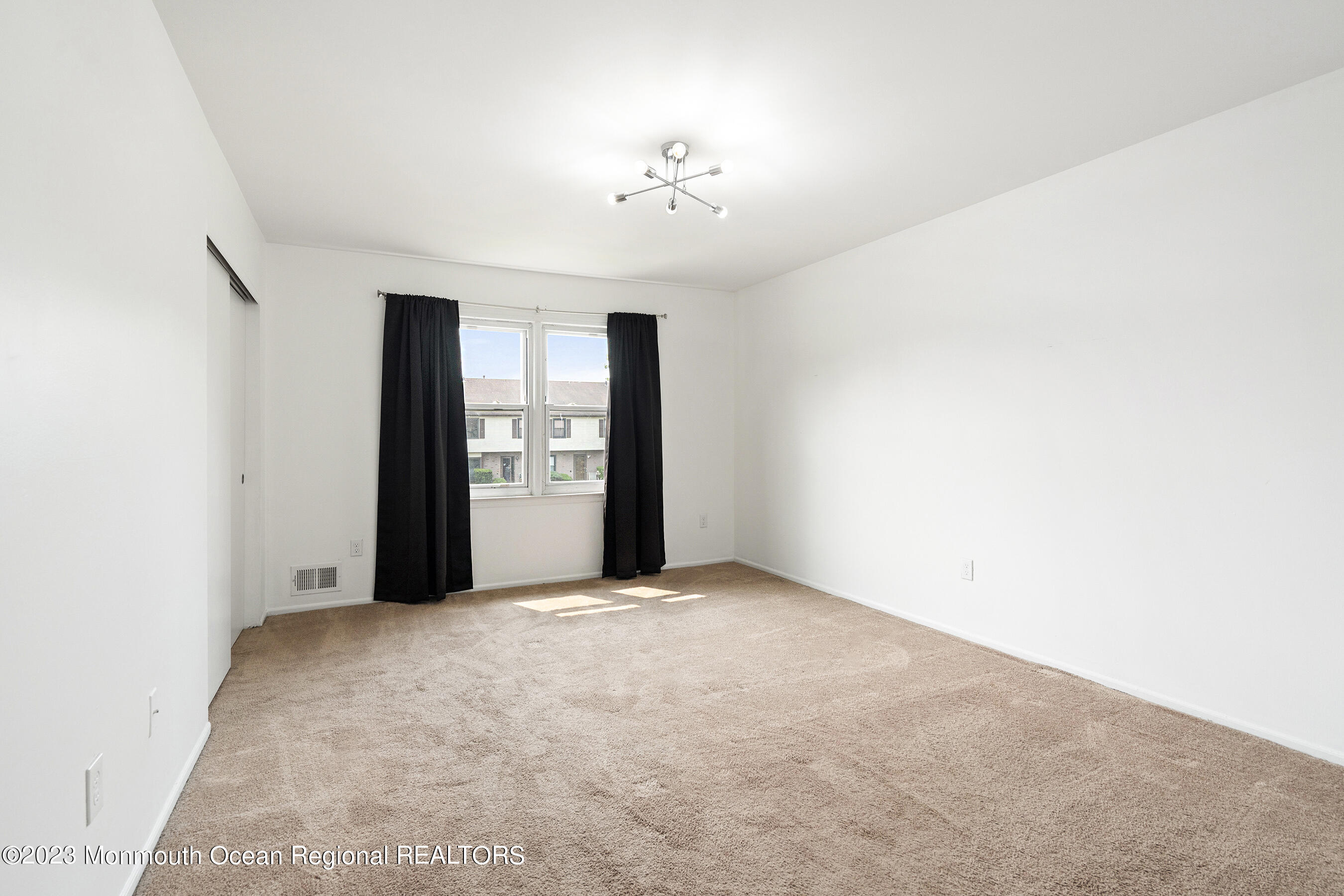 1054 Sawmill Road Brick, NJ 08724 - Photo 13 of 18 an empty room with chandelier fan