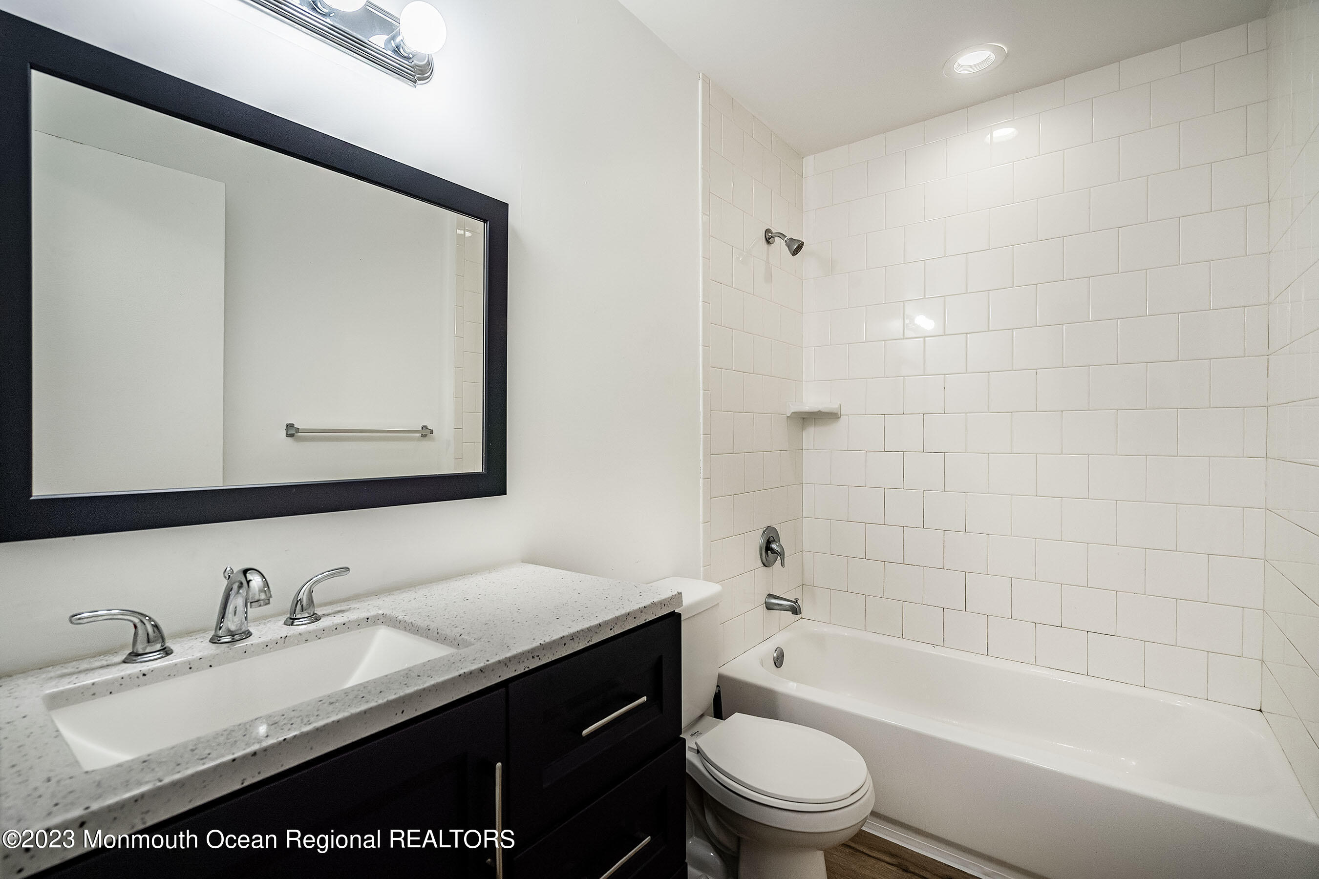 1054 Sawmill Road Brick, NJ 08724 - Photo 14 of 18 a bathroom with a bathtub shower sink vanity mirror and toilet