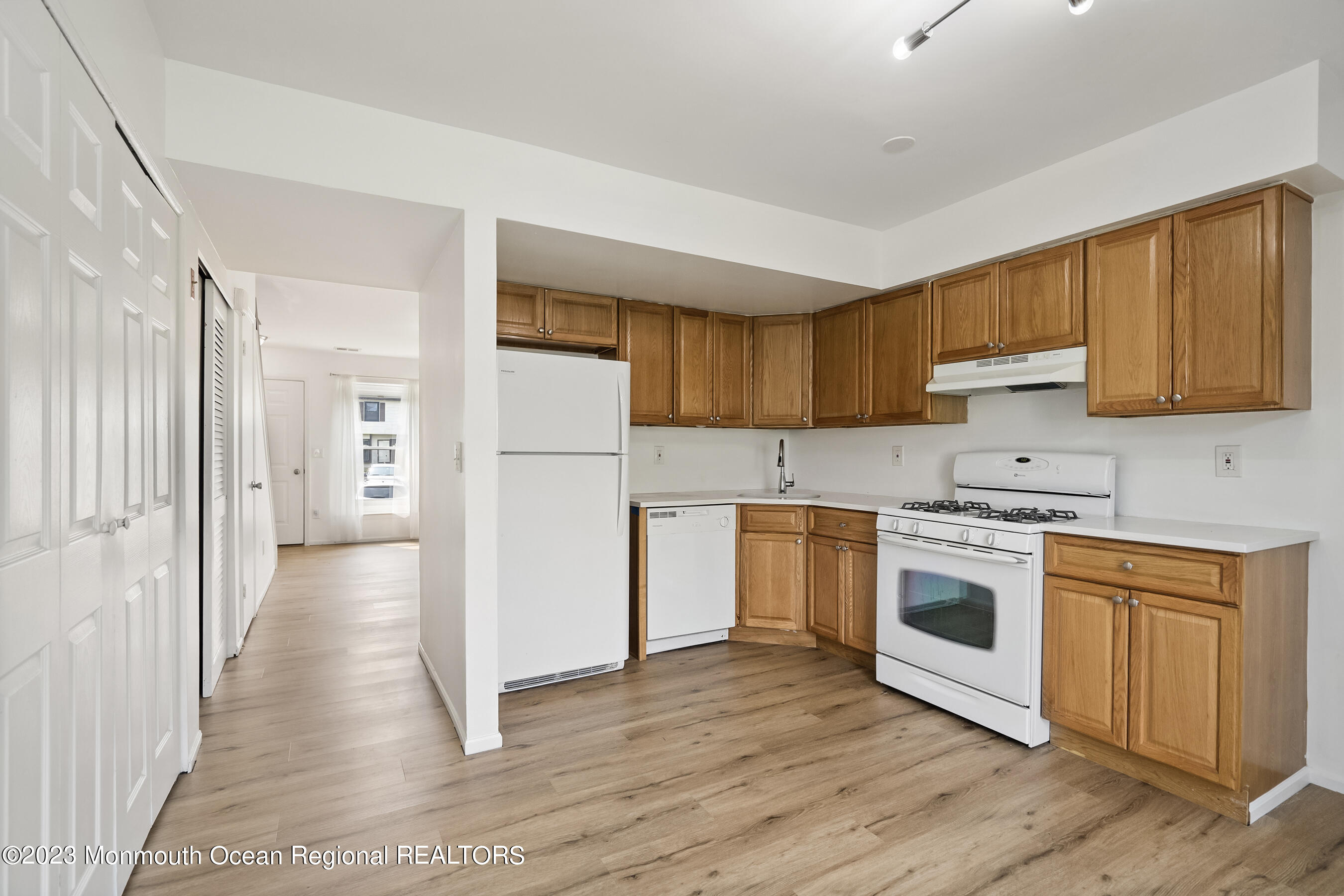 1054 Sawmill Road Brick, NJ 08724 - Photo 9 of 18 a kitchen with a refrigerator a stove top oven a sink and cabinets with wooden floor