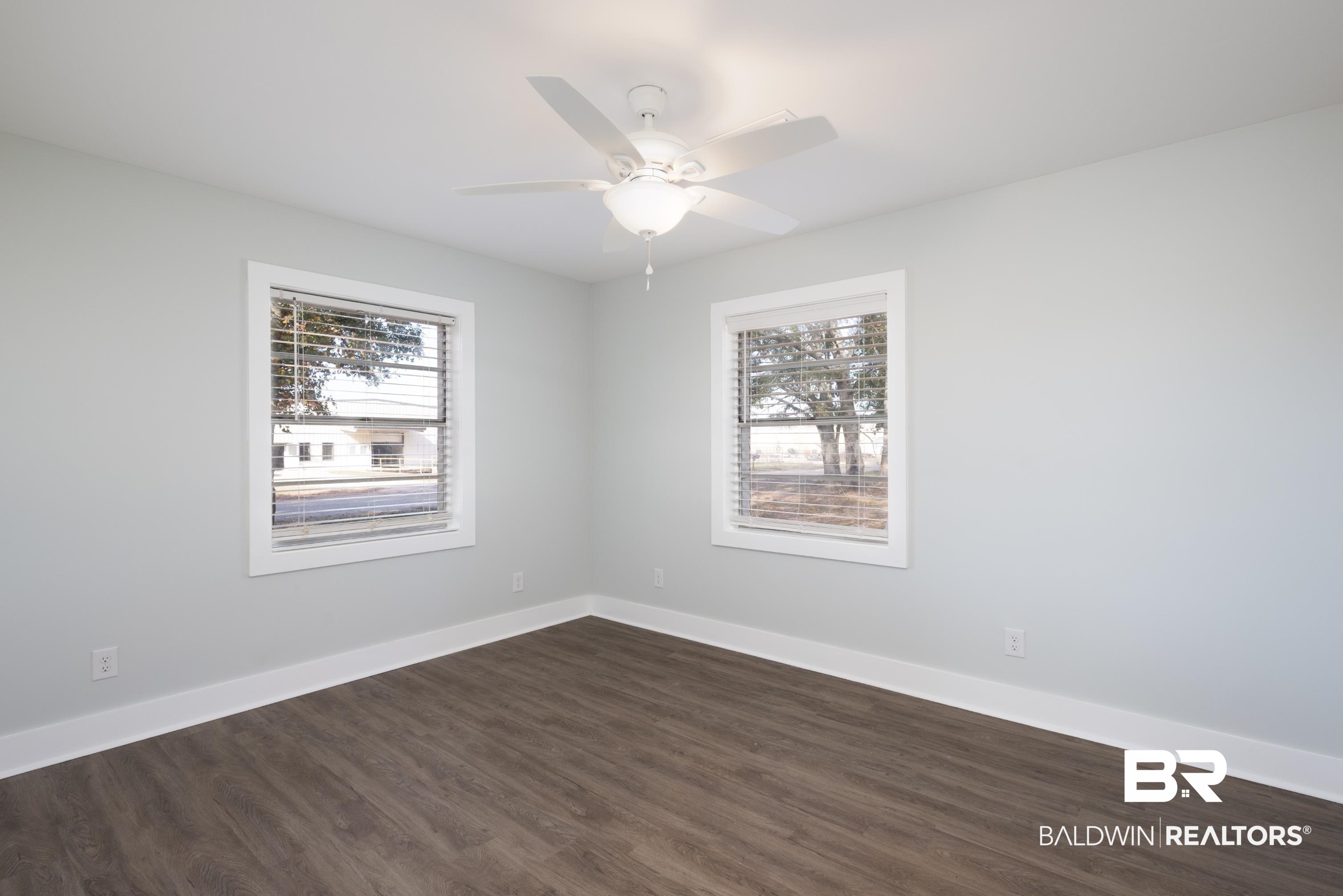 18267 Highway 98 Foley, AL 36535 - Photo 16 of 26 Unfurnished room with dark wood finished floors, plenty of natural light, and ceiling fan