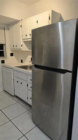a white refrigerator freezer sitting in a kitchen