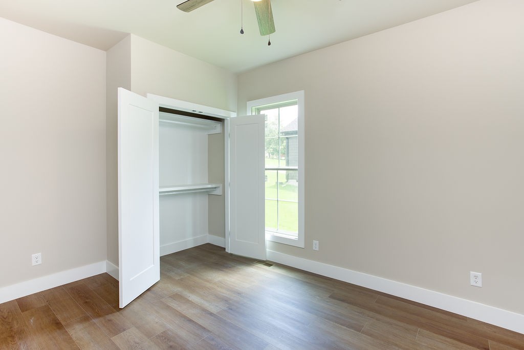 807 Oconner Smithville, TN 37166 - Photo 22 of 33 an empty room with wooden floor cabinet and windows