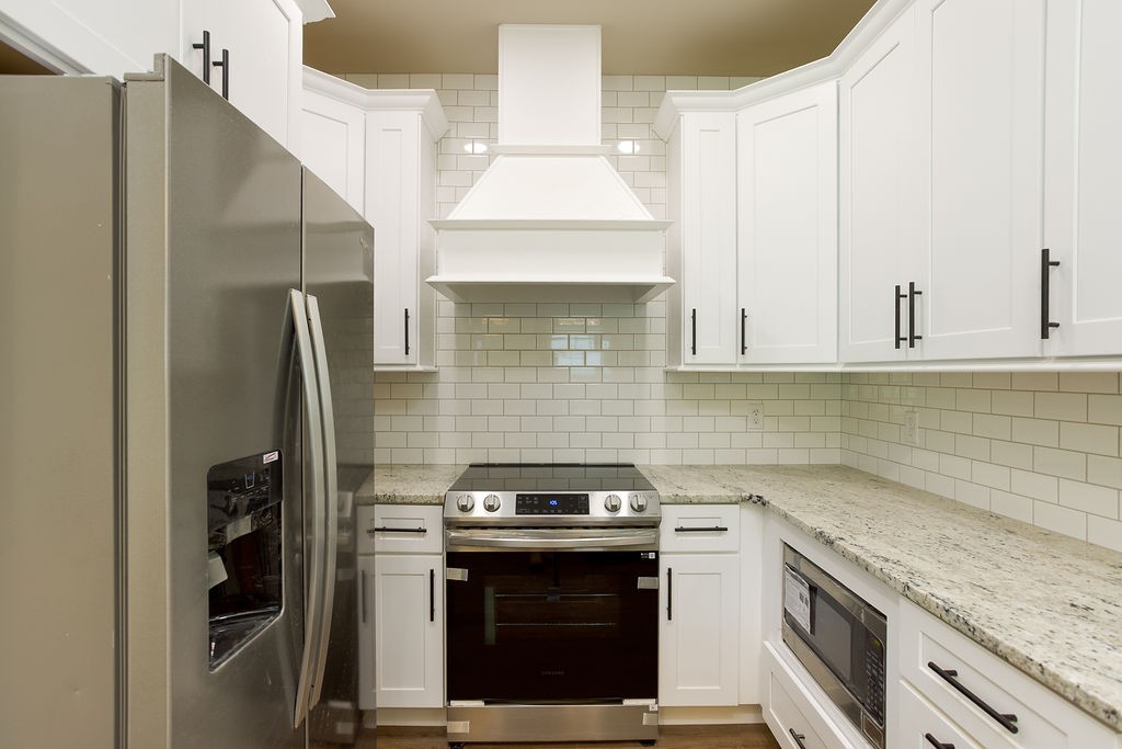 807 Oconner Smithville, TN 37166 - Photo 7 of 33 a kitchen with stainless steel appliances granite countertop a stove a refrigerator and a sink