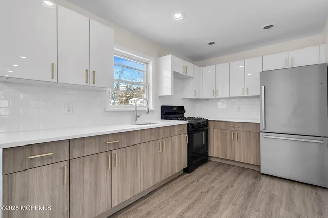 a kitchen with a refrigerator sink and cabinets