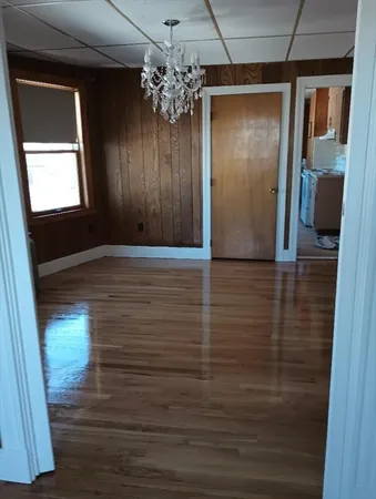 a view of a hallway with a wooden floor
