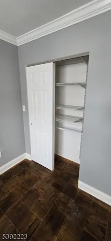 a view of storage and utility room with wooden floor