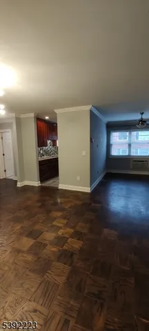 a view of a livingroom with a ceiling fan and hardwood floor