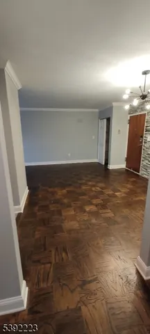 a view of a brick house with a yard and table and chairs next to window