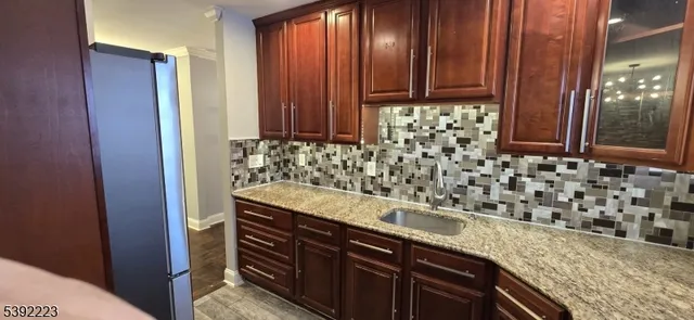 a view of a kitchen with granite countertop cabinets