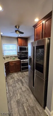 a kitchen with stainless steel appliances granite countertop a refrigerator and a sink