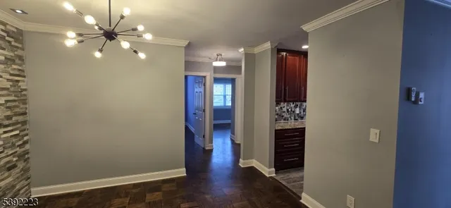 wooden floor in an empty room with a bathroom