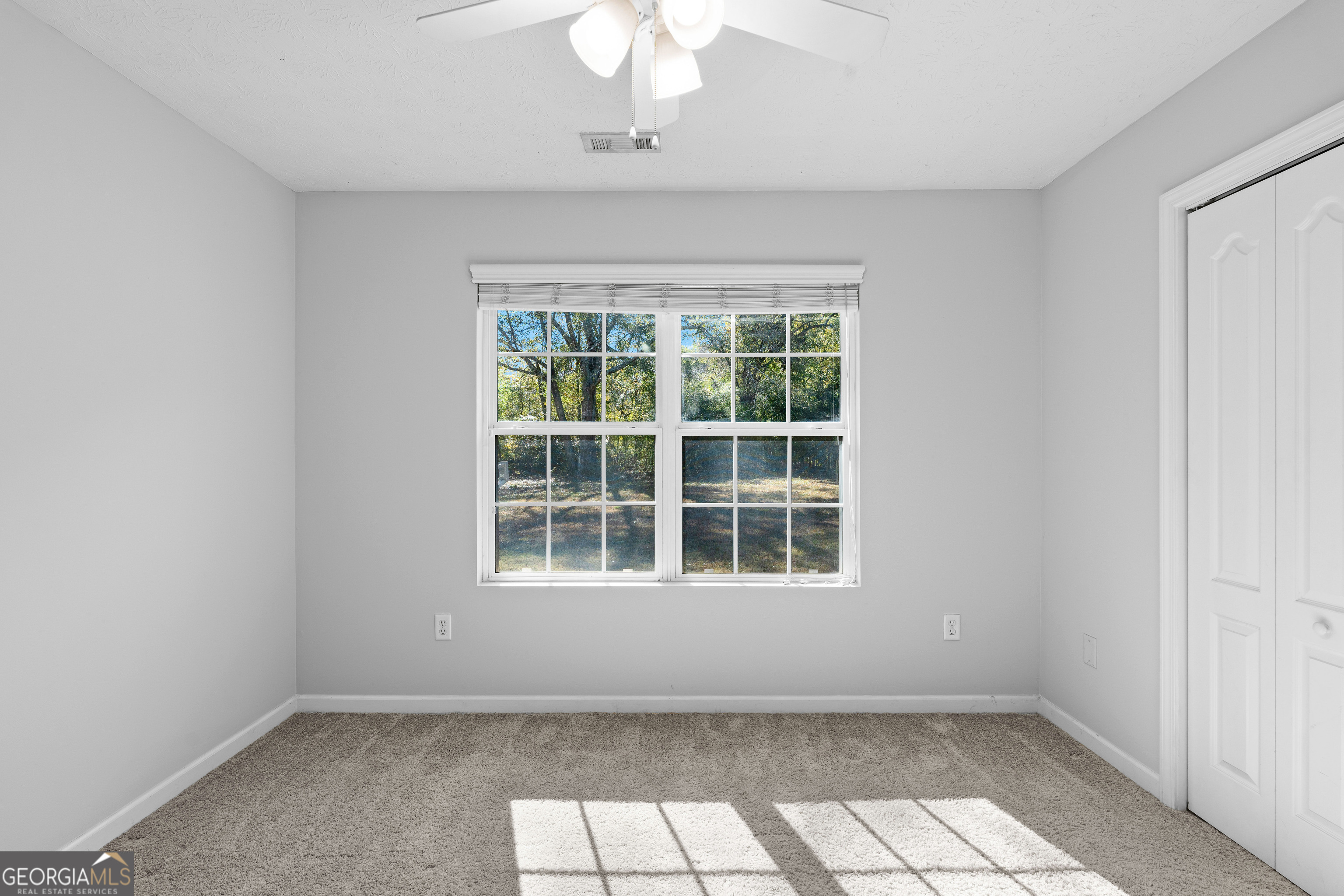47 Matthews Street Senoia, GA 30276 - Photo 15 of 27 an empty room with a window