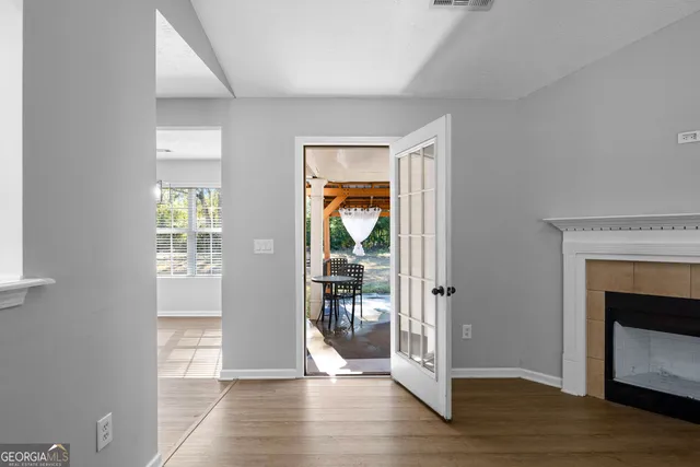 a view of a hallway with wooden floor and a fireplace