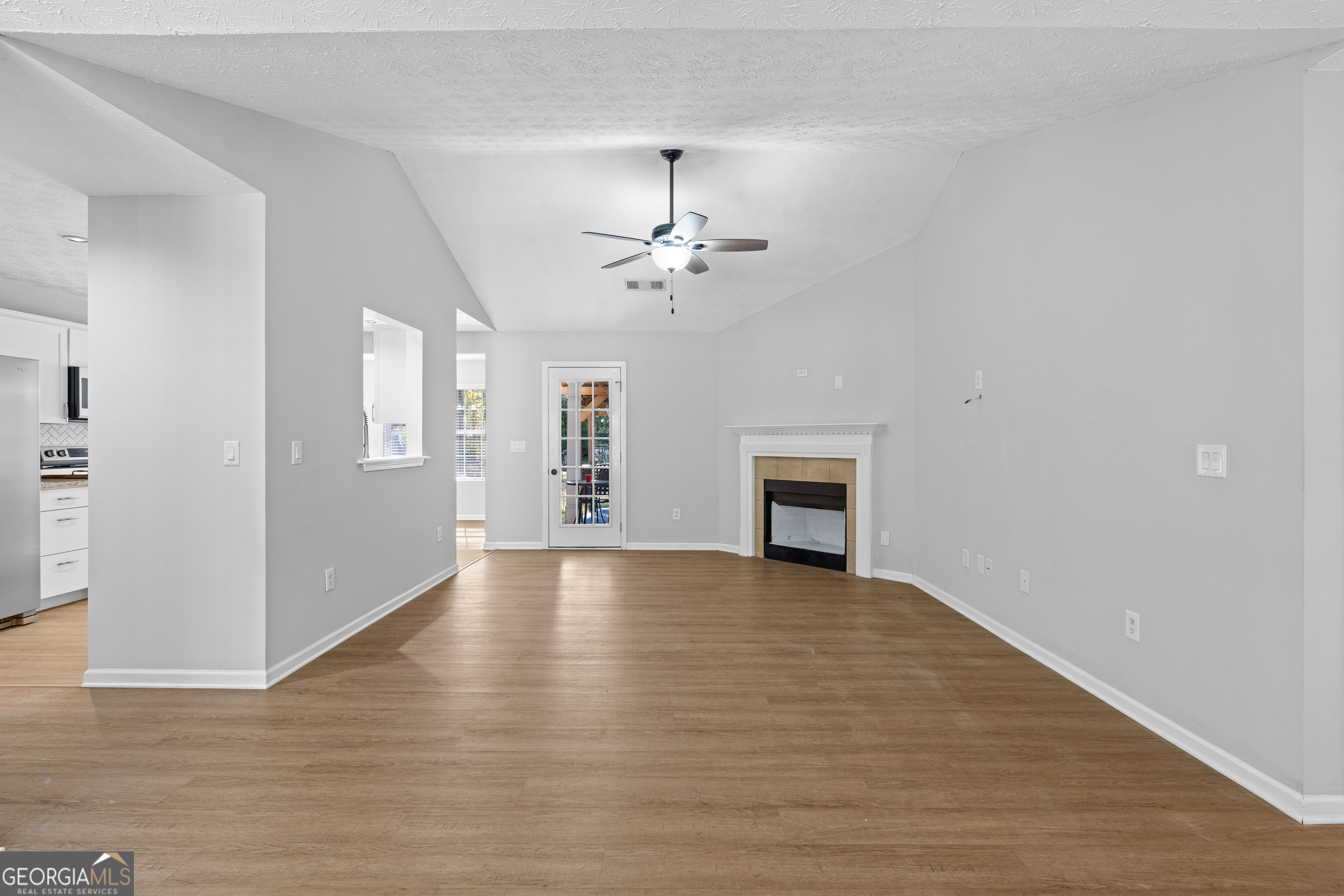 47 Matthews Street Senoia, GA 30276 - Photo 5 of 27 wooden floor in an empty room with a window