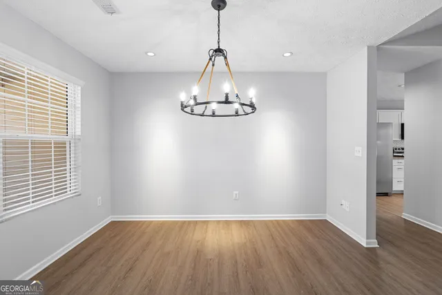 a view of a room with wooden floor and windows