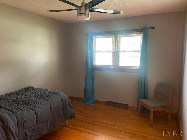 2836 Red House Road Rustburg, VA 24588 - Photo 34 of 74 a bed sitting in a bedroom next to a window