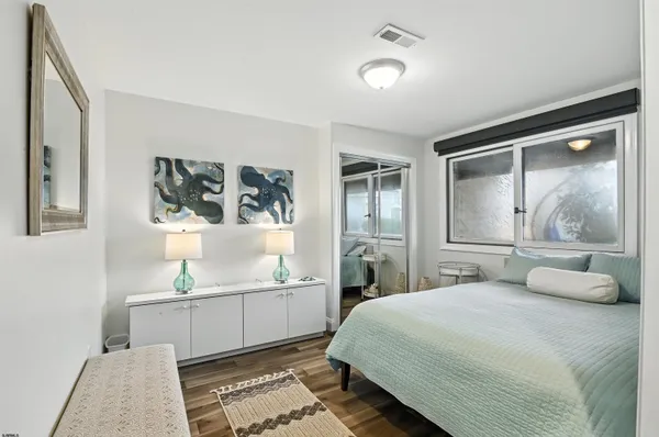 a bedroom with a bed and painting on the wall