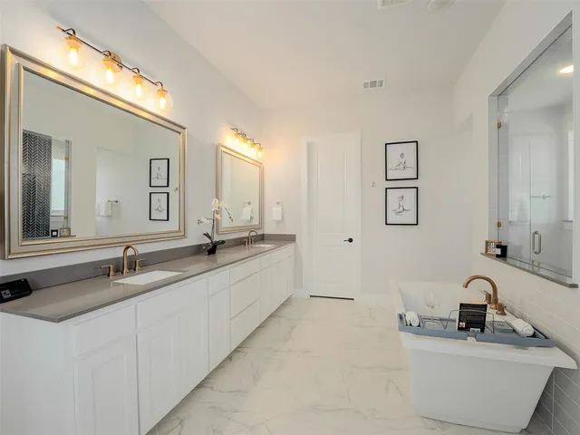 a bathroom with double vanity sinks and a mirror