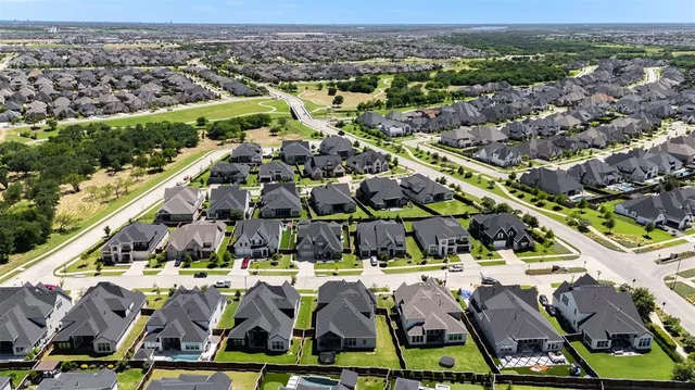an aerial view of residential houses and outdoor space
