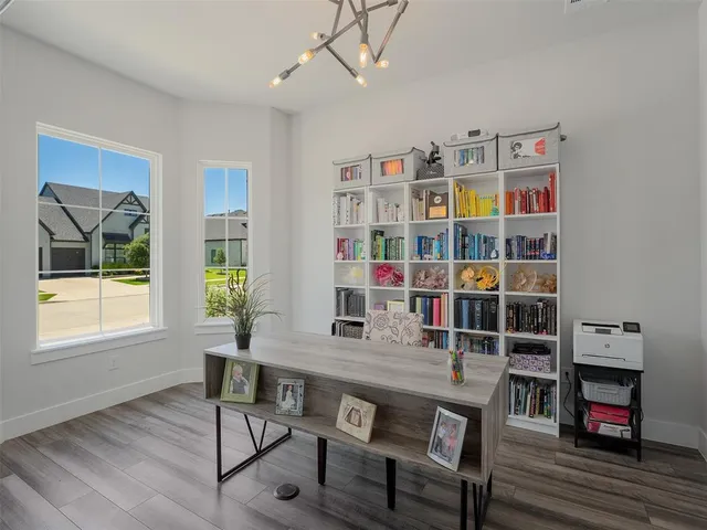 a workspace with furniture and a book shelf