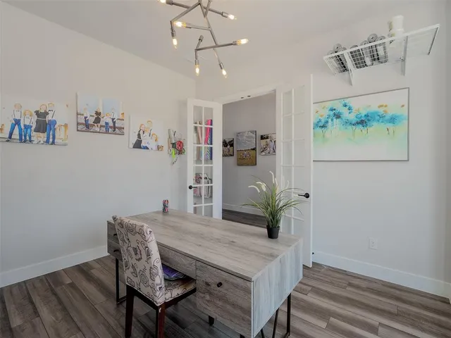 a view of a dining room with furniture wooden floor and a chandelier