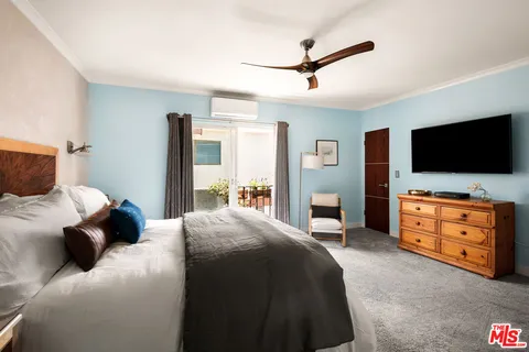 a bedroom with a large bed and a chandelier