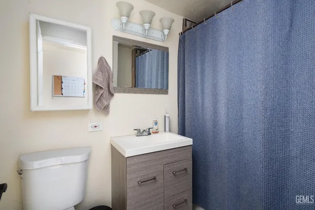 a bathroom with a sink vanity and a mirror