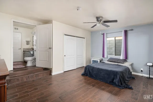 a spacious bedroom with a bed and a chandelier