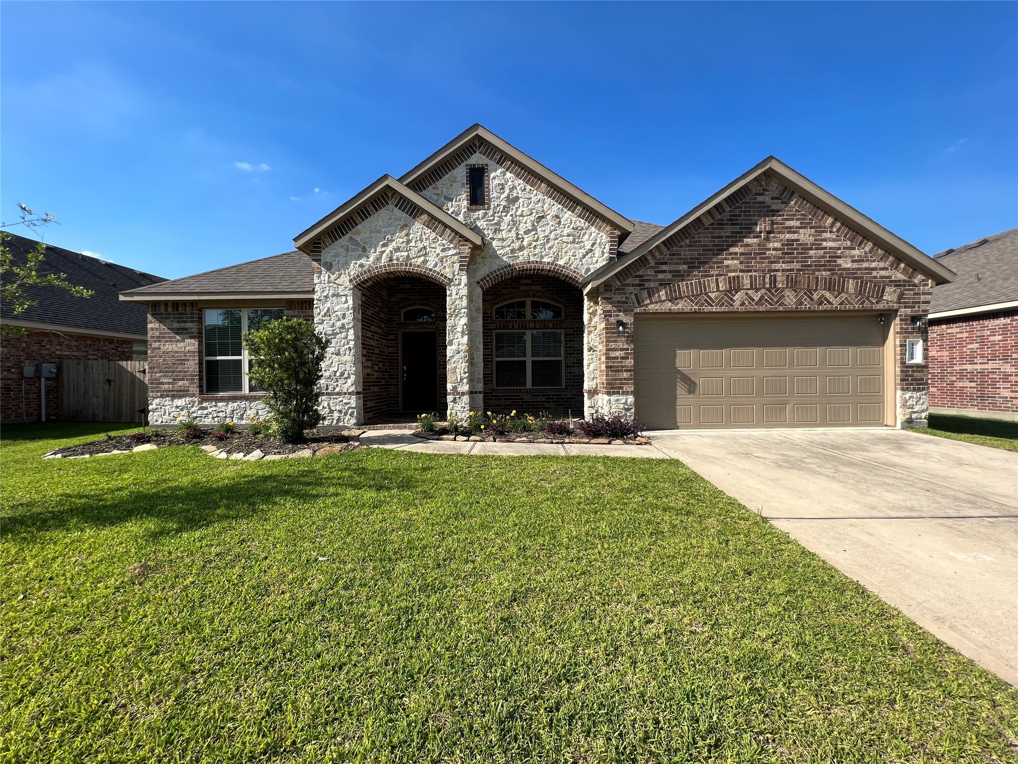 14208 Wallowa Ridge Lane Conroe, TX 77384 - Photo 1 of 48 a front view of a house with garden