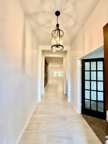 a view of a hallway with a chandelier