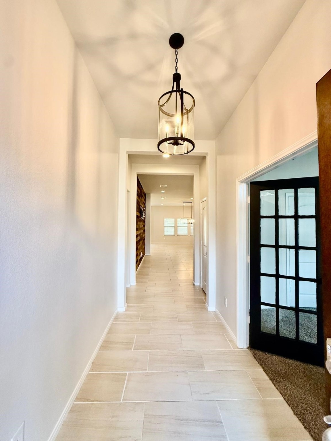 14208 Wallowa Ridge Lane Conroe, TX 77384 - Photo 11 of 48 a view of a hallway with a chandelier