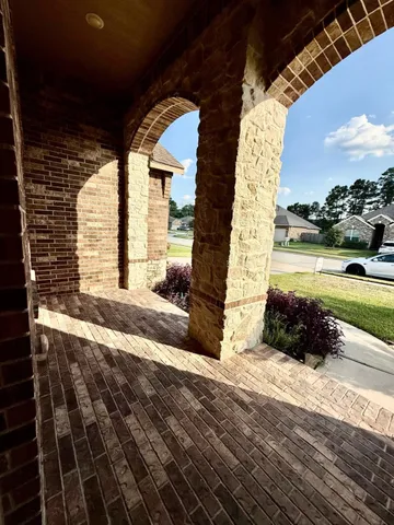 a view of a hallway with wooden floor and entryway
