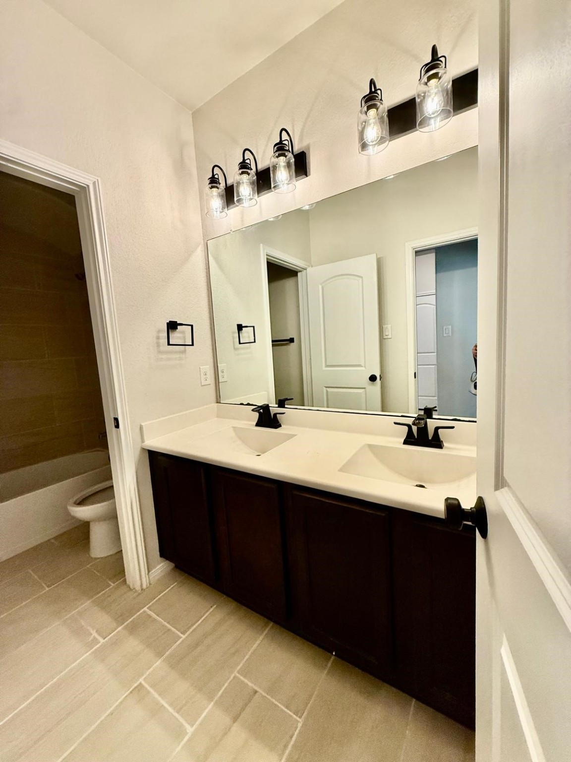 14208 Wallowa Ridge Lane Conroe, TX 77384 - Photo 22 of 48 a bathroom with a double vanity sink and mirror