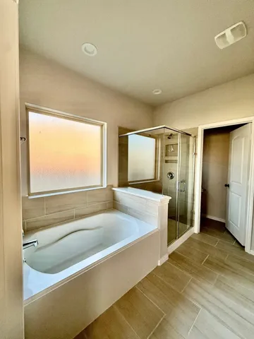 a spacious bathroom with a granite countertop sink a mirror and a