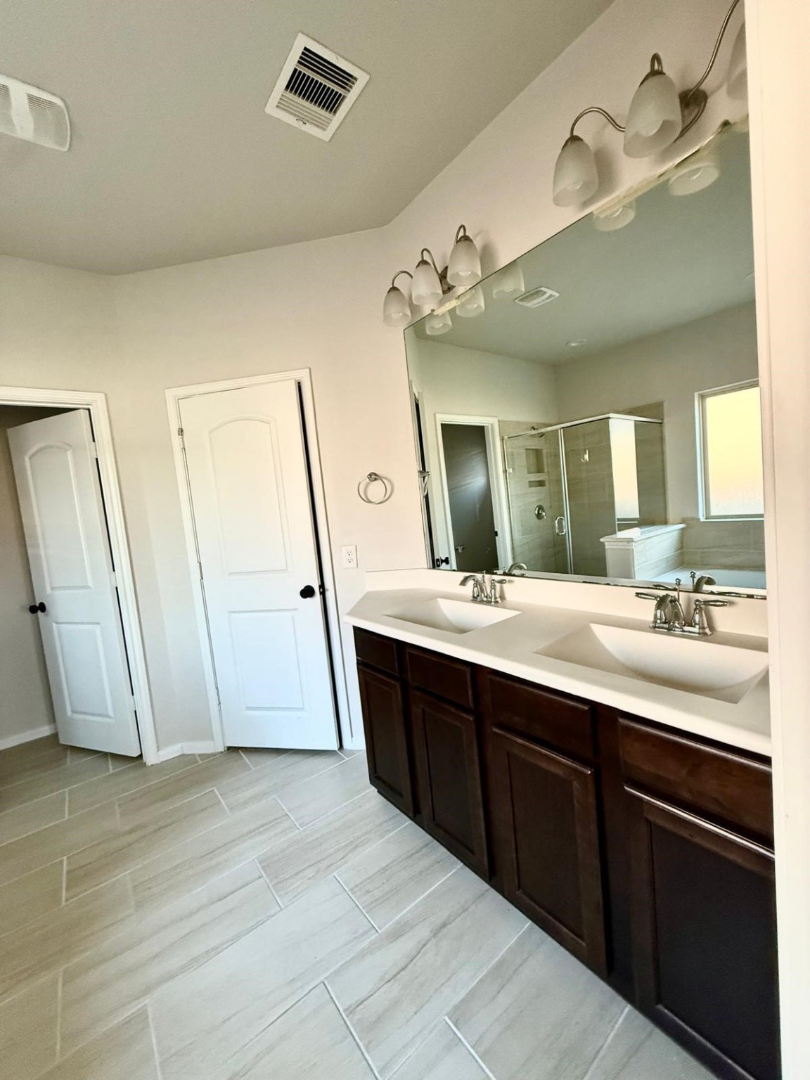 14208 Wallowa Ridge Lane Conroe, TX 77384 - Photo 29 of 48 a spacious bathroom with a granite countertop sink a mirror and a