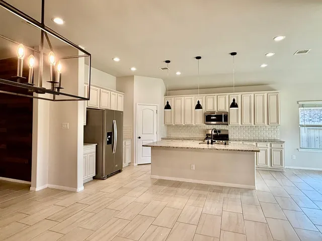 a view of a kitchen with a sink and a stove top oven