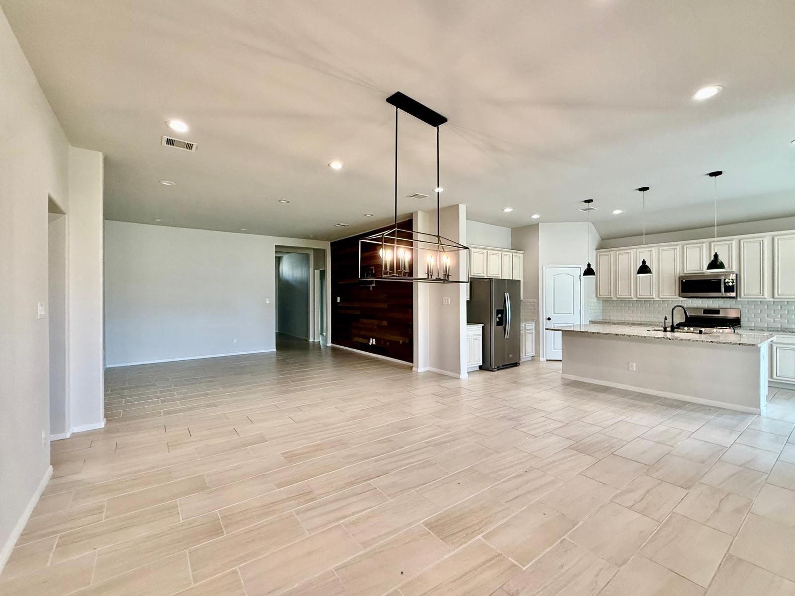14208 Wallowa Ridge Lane Conroe, TX 77384 - Photo 36 of 48 a view of a kitchen with a sink and a stove top oven
